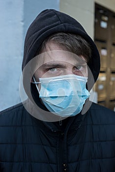 Young man wearing a medcal mask in outdoor during the covid-19 pandemic