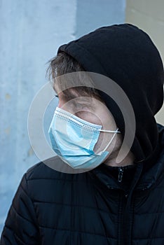 Young man wearing a medcal mask in outdoor during the covid-19 pandemic