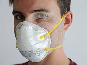 Young Man Wearing an N95 Respirator Dust Mask Up Close photo