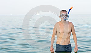 Young man wearing a snorkel and goggles