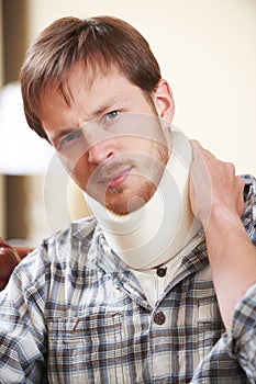 Young Man Wearing Surgical Collar