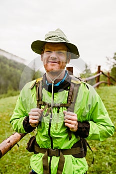 Young man wearing trekking equipment hiking in mountain forest