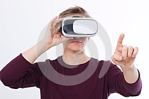 Young Man wearing virtual reality goggles and toch space by finger isolated on white background. VR concept and copy space. Select