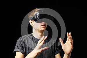 Young Man Wearing Virtual Reality Headset In Studio