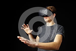 Young Man Wearing Virtual Reality Headset In Studio