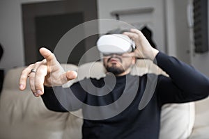Young man wearing VR Goggles and pointing with finger
