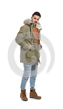 Young man wearing warm clothes on white. Ready for winter vacation