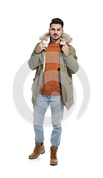 Young man wearing warm clothes on white. Ready for winter vacation