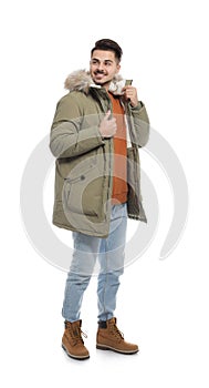 Young man wearing warm clothes on white. Ready for winter vacation