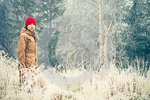 Young Man wearing winter hat clothing outdoor with foggy forest nature on background Travel Lifestyle