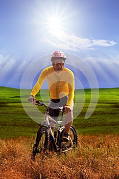 Young man wearing yellow bicycle shirt riding mountain bike mtb