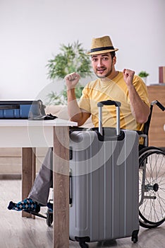 Young man in wheel-chair preparing for departure at home