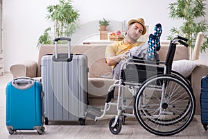 Young man in wheel-chair preparing for departure at home