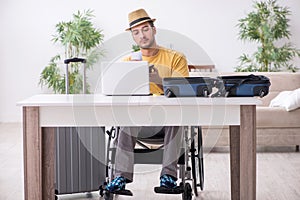 Young man in wheel-chair preparing for departure at home