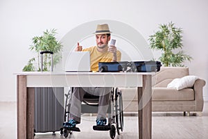 Young man in wheel-chair preparing for departure at home