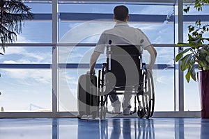 Young man in a wheelchair at the airport