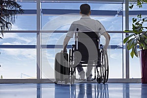 Young man in a wheelchair at the airport photo