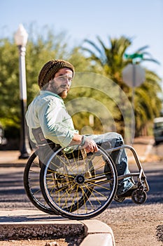 Young Man in Wheelchair at City Curb