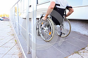 Young man in wheelchair on ramp outdoors photo