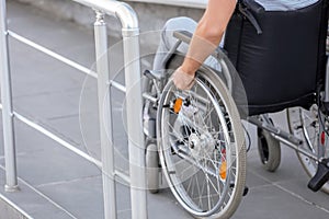 Young man in wheelchair on ramp outdoors photo