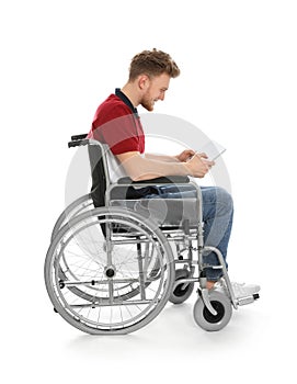 Young man in wheelchair using tablet