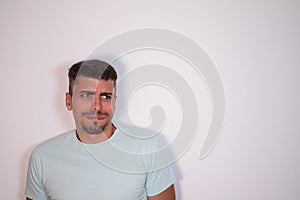 Young man on a white background looking disappointed and disappointed. Concept different expressions