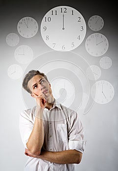 Young man in white and clock. Time is passing