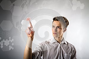 Young man in white pushing the button. Innovative technology concept