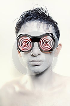 Young man with white skin in strange glasses