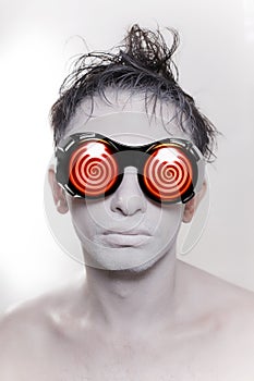 Young man with white skin in strange redglasses