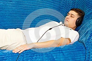 A young man in a white t-shirt at home listening to relaxing music. relaxation relaxation, calmness