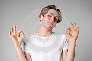 Young Man in White T-Shirt Making OK Gestures With Both Hands