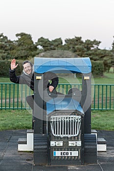 A young man who refuses to grow up enjoying children`s play equipment reliving his youth