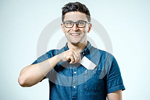 Young man who takes out blank business card from pocket of shirt