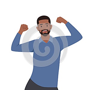 Young man winning at work. Businessman with fist up happy