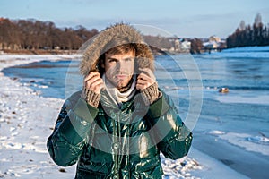 young man in winterwear jacket. man in winterwear outdoors. stylish man in winterwear