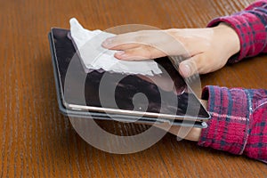 young man wipe gis gadgets screen with wet napkin