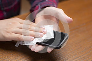 young man wipe gis gadgets screen with wet napkin