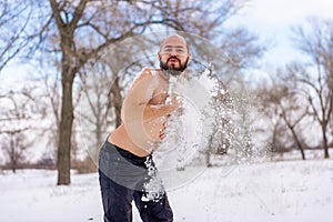 Young Man wiping snow in the winter, to promote health.