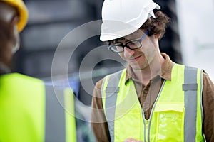 Young man and woman is architect planning and inspector project and looking digital tablet at construction site.