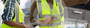 Young man and woman is architect planning and inspector project and looking digital tablet at construction site.