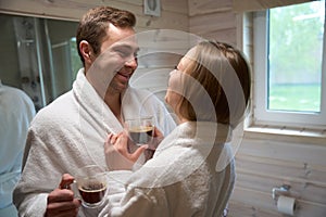 Young man and woman in the bathroom looking at each other