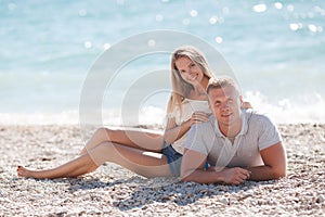 Young man and woman on beach in summer