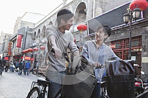 Young man and woman with bicycles and backpacks.