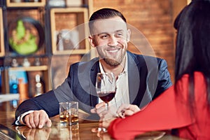 Young man and woman celebrating in restaurant