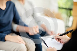 Young man and woman consulting with professional consultant.