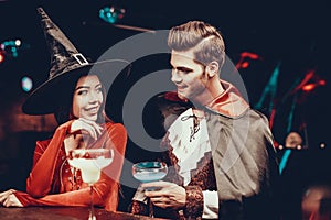 Young Man and Woman in Costumes at Halloween Party