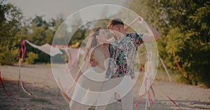 Young man and woman dancing bachata at beach