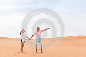 Young Man Woman In Desert Beautiful Couple Asian Girl And Guy Point Finger Sand Dune