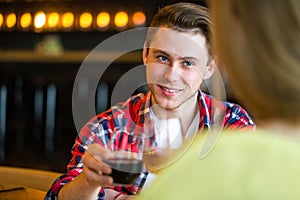 Young man and woman drinking wine in a restaurant. Young man and woman drinking wine on a date. man and woman on a date